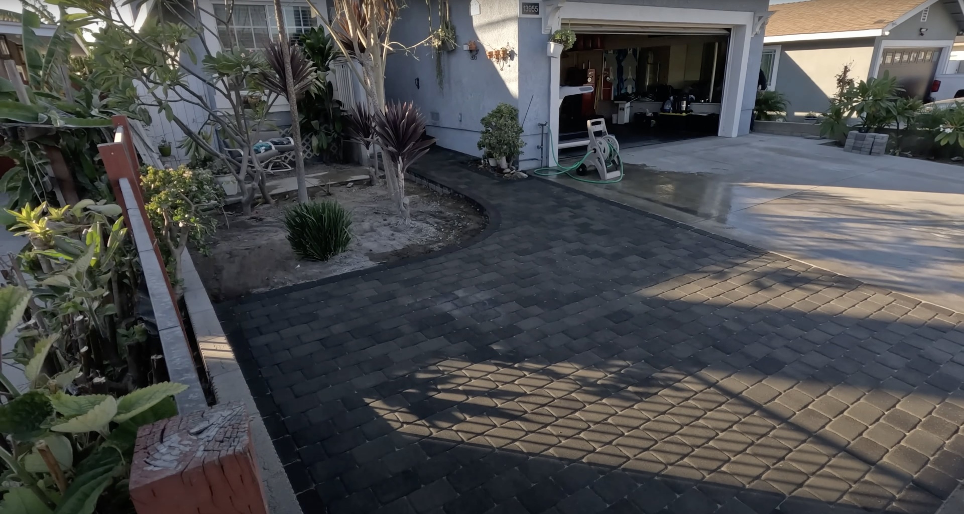 High-quality concrete driveway with decorative pavers and professional installation