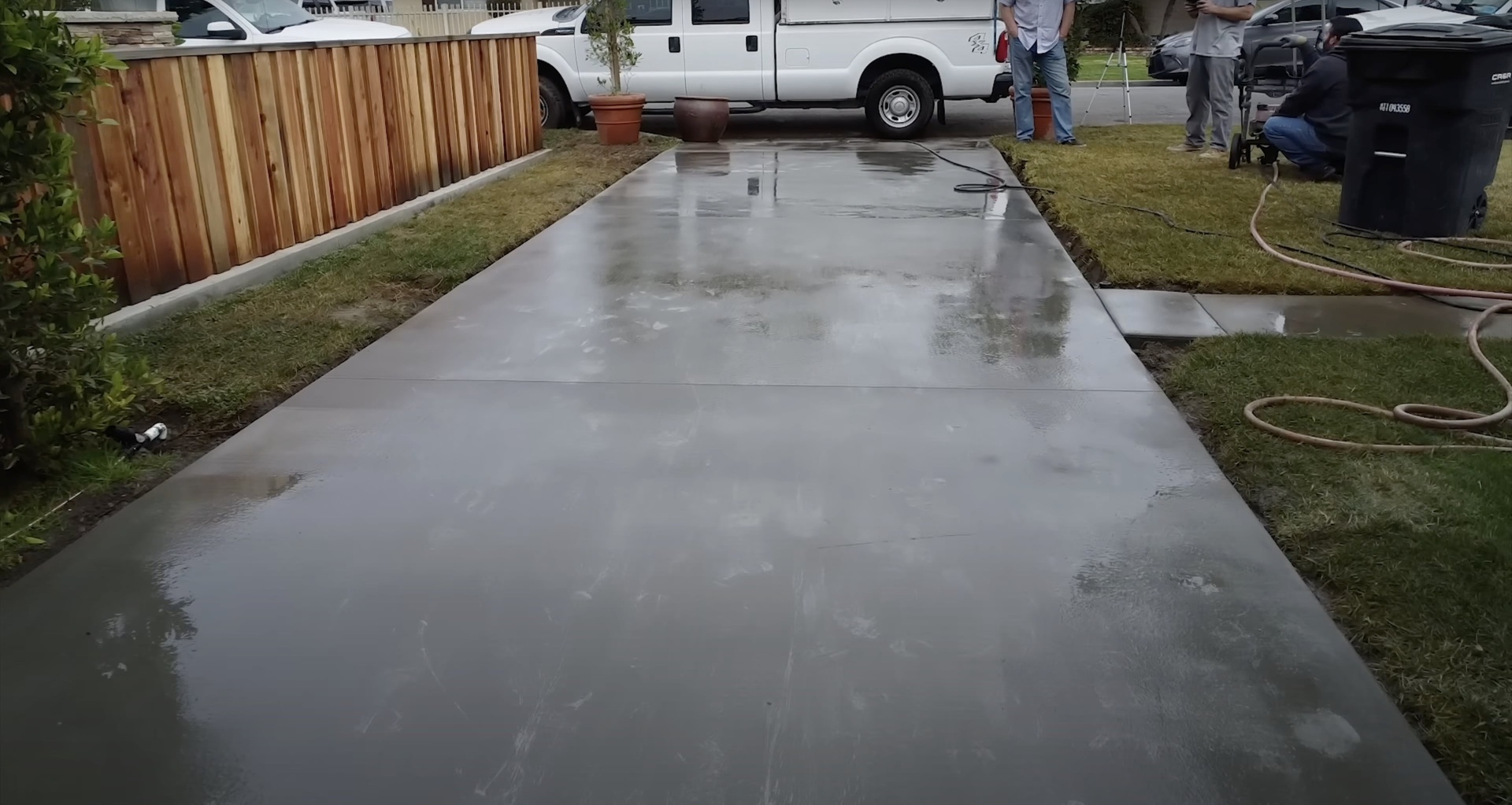 Newly completed smooth concrete driveway with professional finish showcasing quality concrete construction