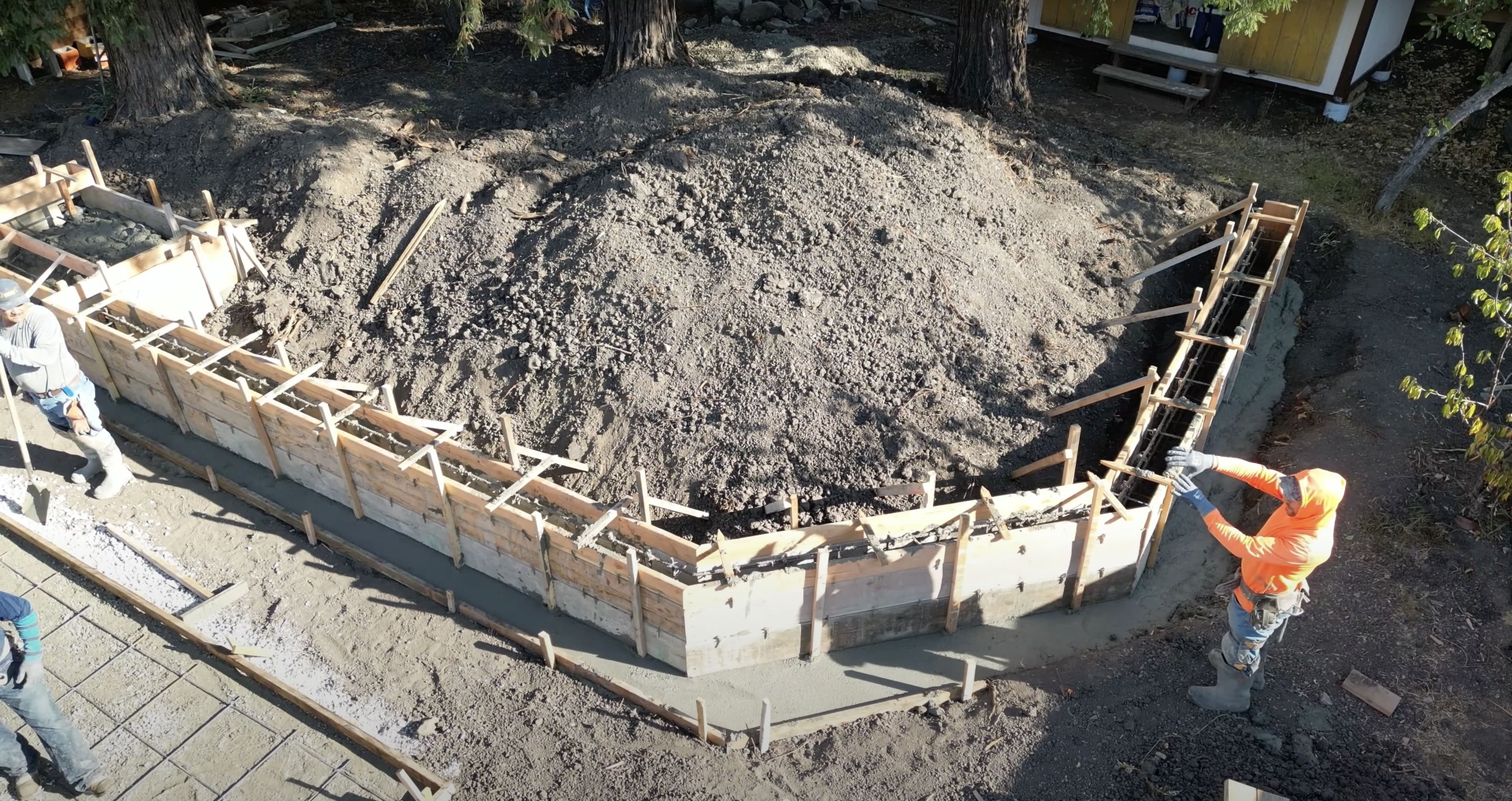 Concrete foundation construction site with wooden forms and excavation preparation for commercial project